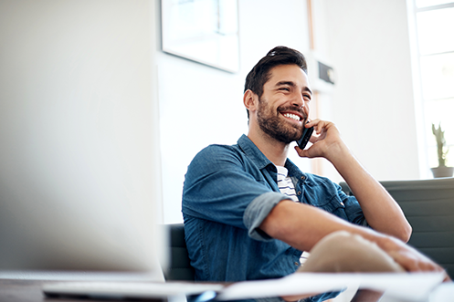 Handsome man with dark hair and beard, talking on a phone, getting ready to Choose Relocation Technology Career Services