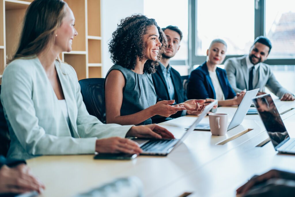 group of employees smiling while in meeting