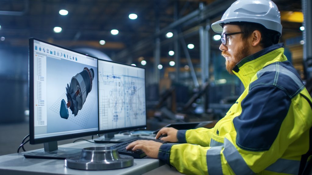 construction worker using computer to review plans.