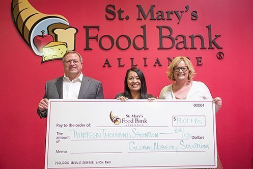 events Steven R. Wester, President (left), and Ann Knapp, Director of Transportation Services (right), present a check from Global Mobility Solutions for 2018 and 2019 Forum donations to Genevieve Villegas, Corporate Giving Officer (center), St. Mary's Food Bank Alliance.