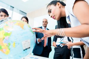 office team looking at a globe.