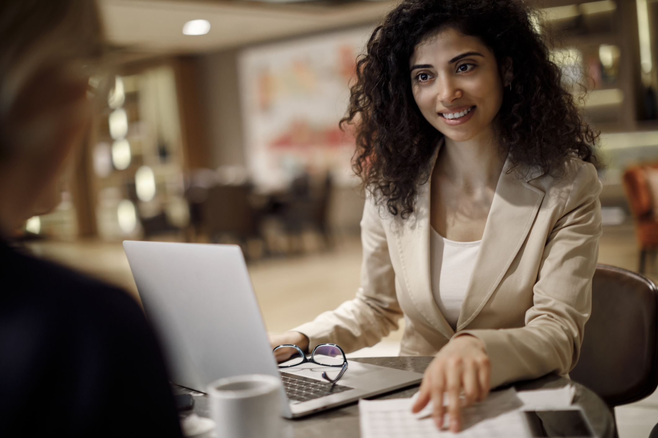 young professional woman reviewing work with a coworker