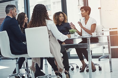 One man and four women, all employees at a company, conducing a relocation policy review