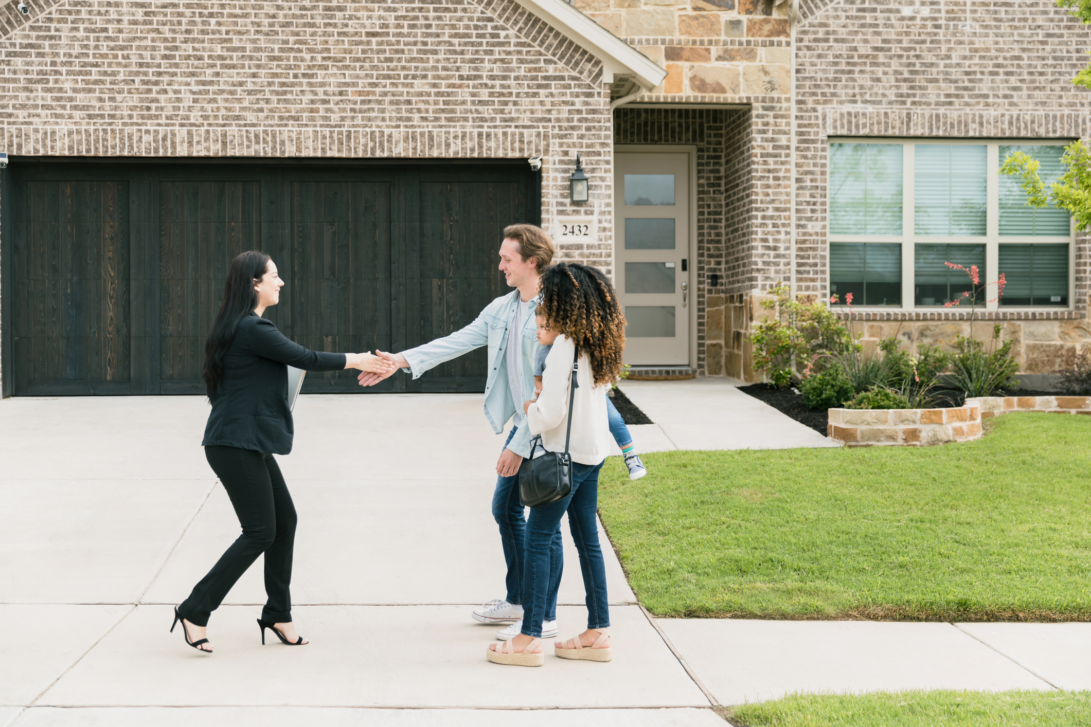 real estate agent meeting a newly wed couple with young kid