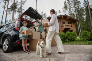 A family unpacking boxes from car after an international relocation