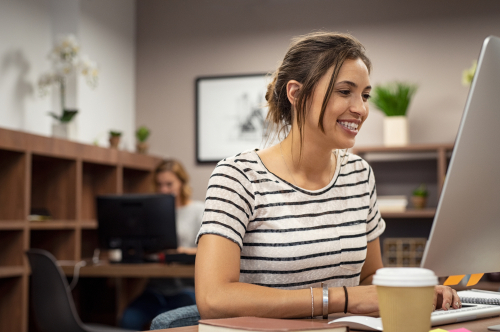 young woman working on filing taxes on computer