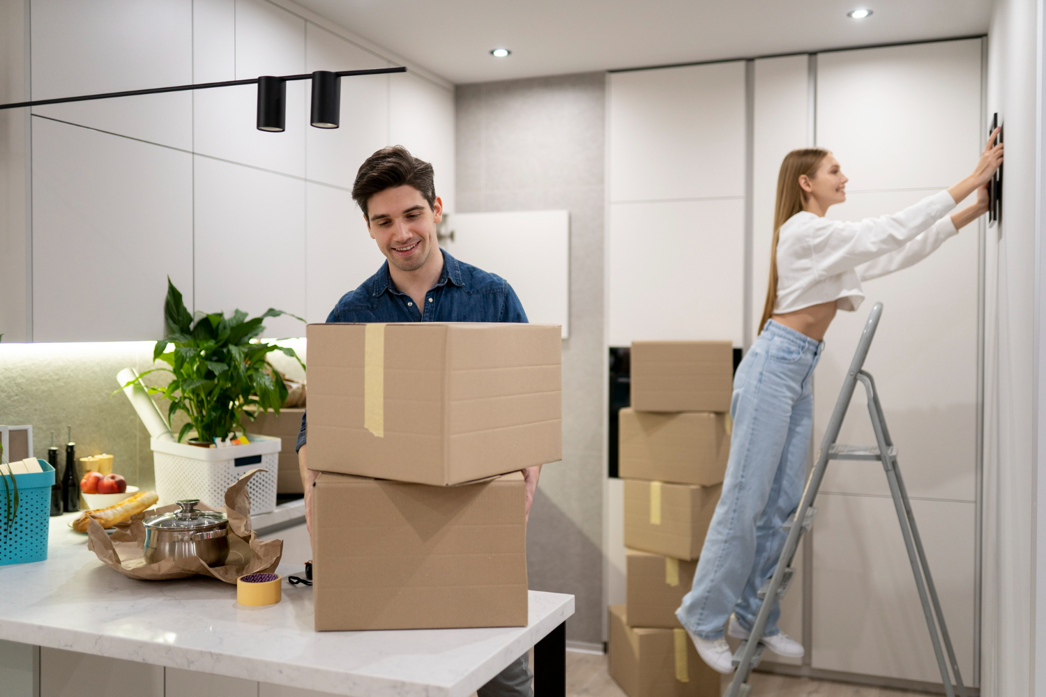 a man and a woman packing after navigating the legalities of corporate relocation