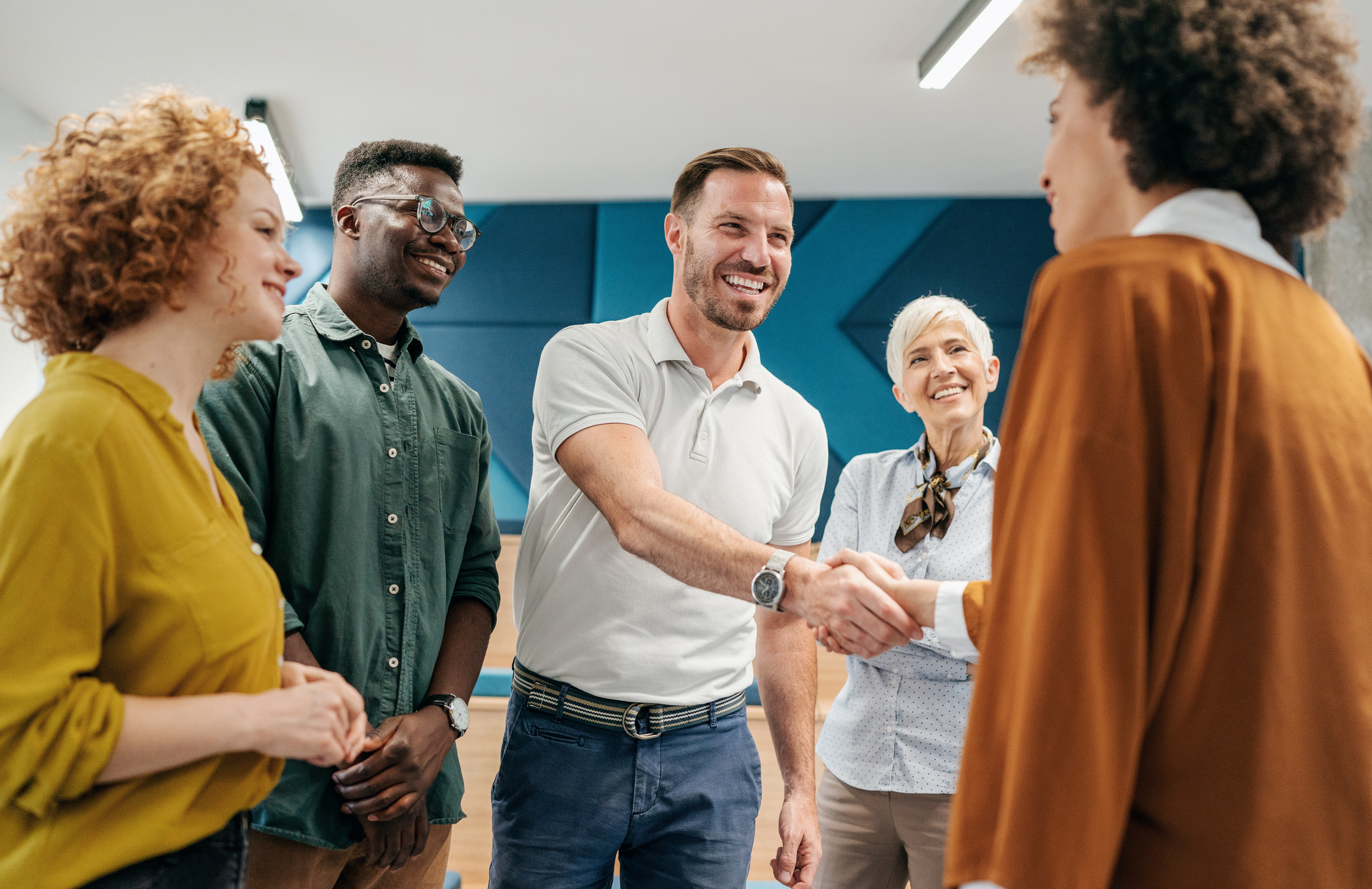 Happy businessman shaking hands with colleague on a meeting in the office.