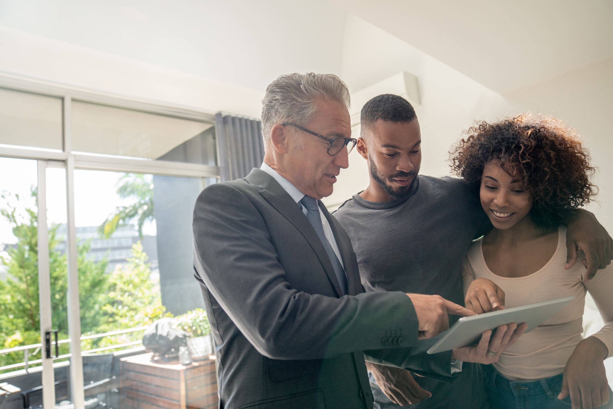 Real estate agent showing a property to an African American couple
