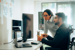 two employees looking at computer for data privacy