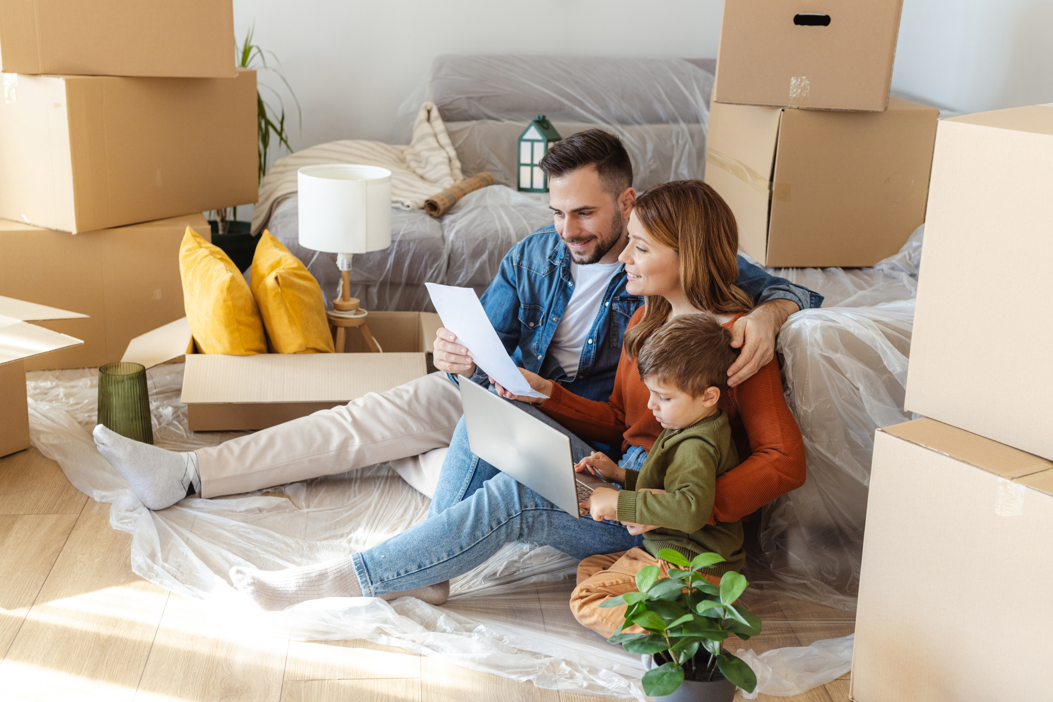 Family in their living room with moving boxes.