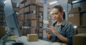 Female logistics worker scans package