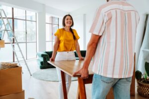 young couple happily moving into their new home.