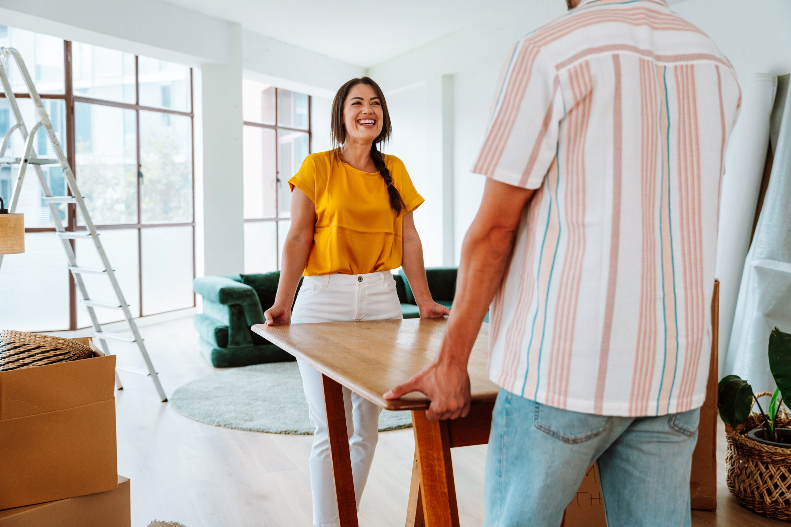 young couple happily moving into their new home.