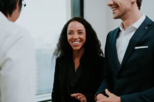 Young African-American female employee smiling in meeting.