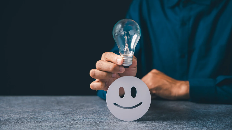 lightbulb over a smile face for happy employee