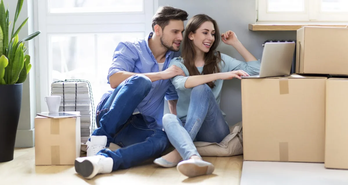 Couple with Moving Boxes and Laptop