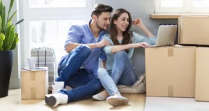 Couple with Moving Boxes and Laptop