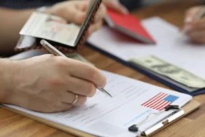 woman filling out visa and immigration paperwork