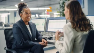young woman asking her manager about relocation assistance