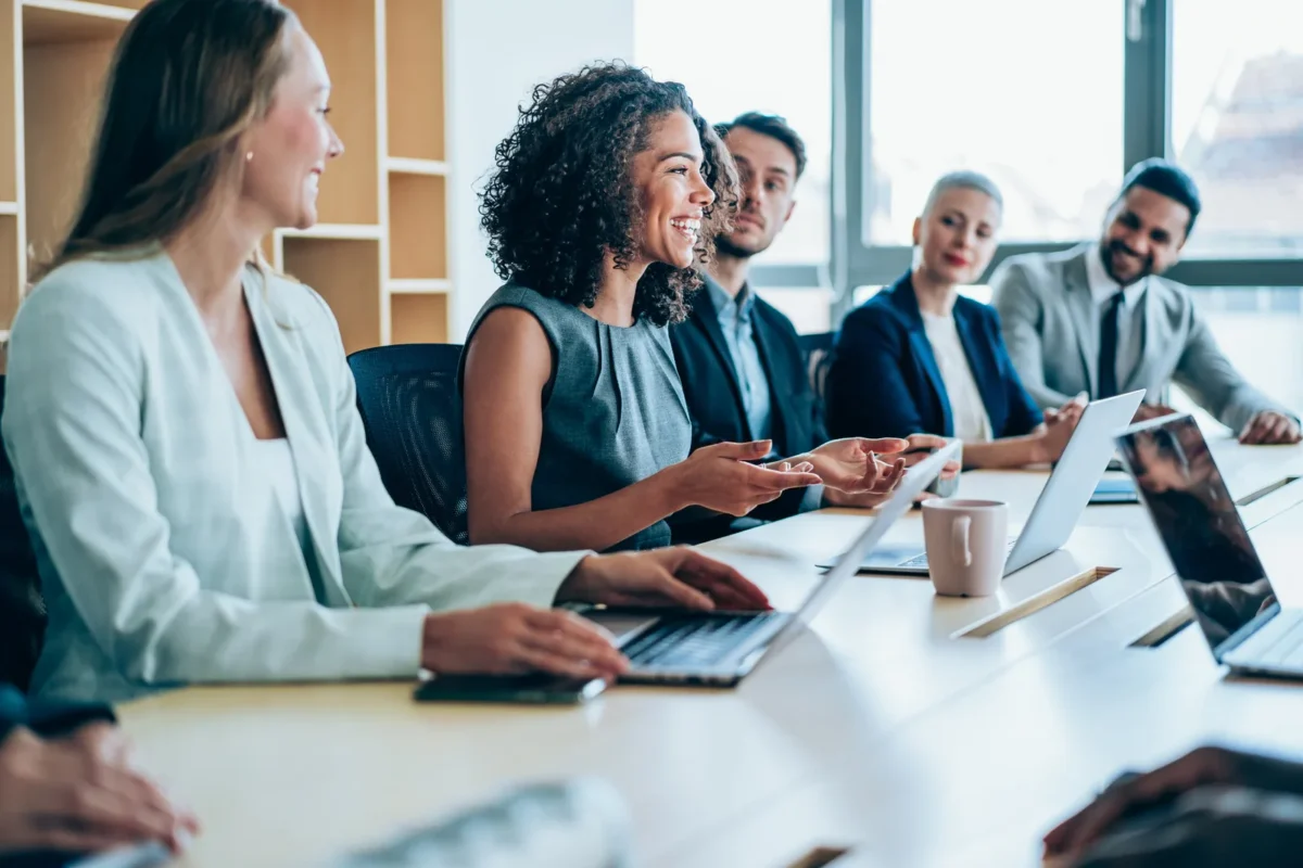 group of employees smiling while in meeting