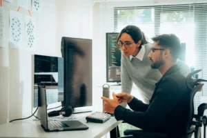 two employees looking at computer for data privacy