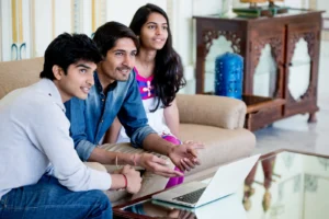 family in living room looking at laptop
