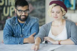 two young adults reviewing world map